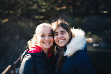 Young girls couple together in nature in winter