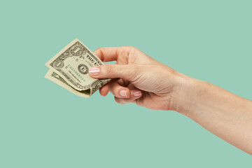 woman hand holding one dollar isolated on green background