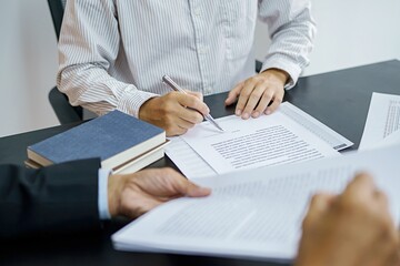 Legal counsel presents to the client a signed contract with gavel and legal law. justice and lawyer concept