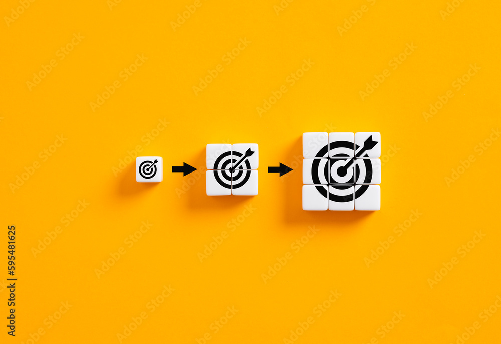 Poster setting business goals. developing goals and objectives. growing target symbols on white cubes on ye
