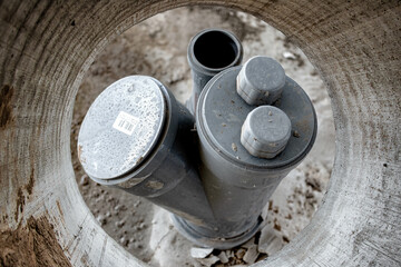 Sewer pipes in home basement. System of gray sanitary pipes in old house.