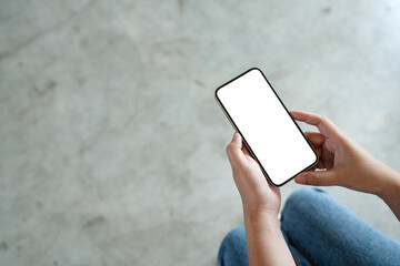 Hand holding empty white screen smart phone on white background.