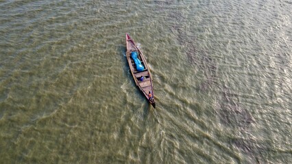 arial drone view of wooden boats moving in chilika lake in deep water