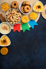 Festa Junina Summer Festival Carnival concept. Brazilian straw hat, popcorn, peanuts and Corn Cakes on Wooden Background for Brazilian Festa Junina Summer Festival