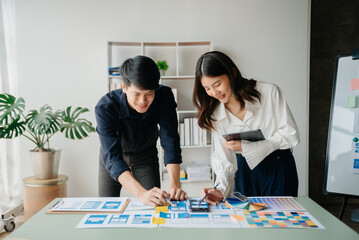 Fototapeta premium Asian businessman and woman people meeting in office. Employee brainstorm and work as team, plan and discuss project by point on paper and tablet. .