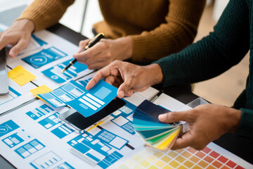 UI designer UX developer andbrainstorming about mobile app interface wireframe design with customer...
