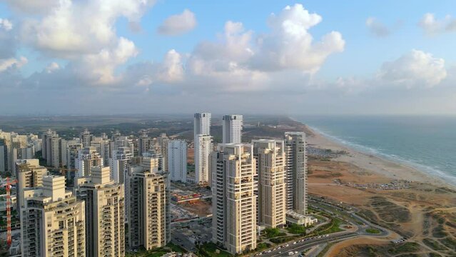 Netanya, Israel, September 3, 2022. Aerial view of the construction of new apartment buildings on the Mediterranean coast in Israel. The new residential area of skyscrapers. High-quality video 4K