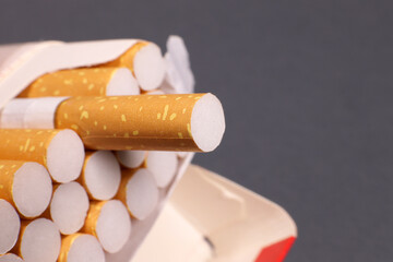 Open pack of cigarettes on a gray background