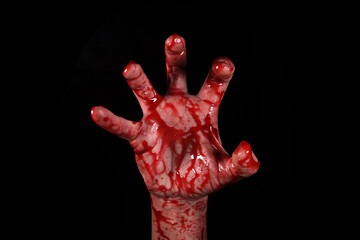 Raised bloody creepy hands on a black background, the concept of murder, nightmares, Halloween