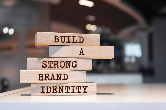 Wooden blocks with words 'Build a strong brand identity'. Business concept