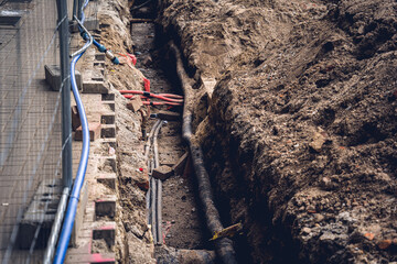 Big construction site with pipes and wires in the construction area.