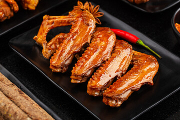The duck's wings were boiled and placed on a  plate