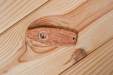 Kazoo is a musical wind instrument made of wood, filmed on a wooden surface.