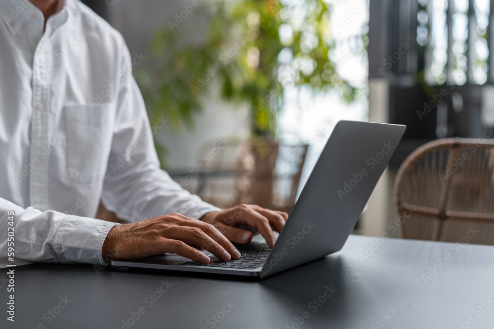 Poster man hands typing on the laptop keyboard with cafe on background