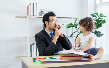Caucasian handsome father wearing eyeglasses and formal suit talking on the phone and working while...