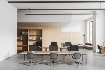 Cozy office interior with workplace and lounge zone near panoramic window