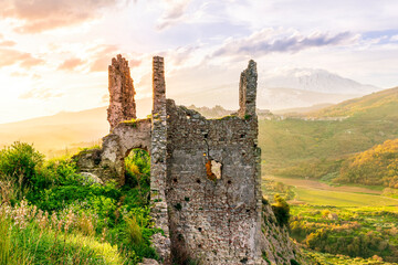 picturesque view from a mountain with ancient monument or castle ruins to a green valley with...