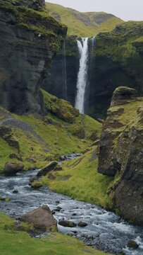 Iceland spectacular Kvernufoss waterfall Summer scene of mountain river in secluded green ravine Beauty of nature concept background