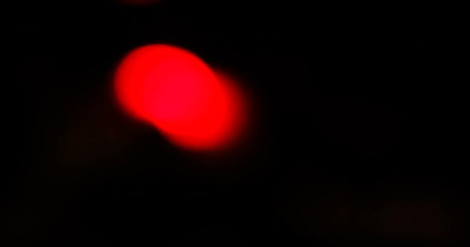 defocused video of the sires of a police squad car outside in the night