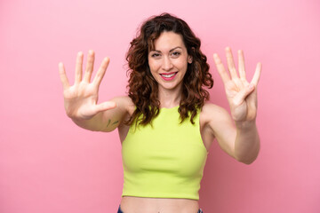 Young caucasian woman isolated on pink background counting nine with fingers