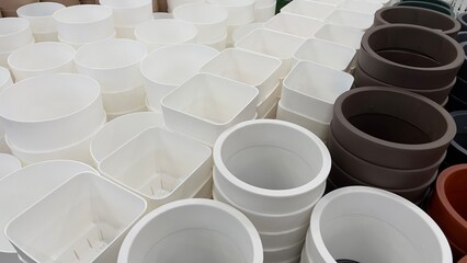Close-up of empty flower pots in a store or greenhouse. Colorful pots for plants. Gardening and landscape design concept