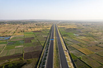 orbit aerial drone shot of new delhi mumbai jaipur express elevated highway showing six lane road...