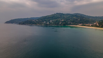 Beautiful beach with colorful water. Top view of the beautiful coastline. Sunny summer day. Colorful water. Sandy beach.