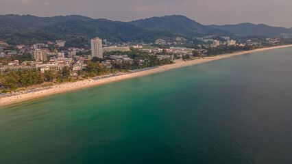 Beautiful beach with colorful water. Top view of the beautiful coastline. Sunny summer day. Colorful water. Sandy beach.