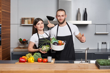Young couple coocking salad in the kitchen