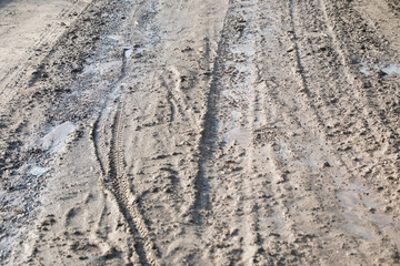 Mud, puddles, a country road after rain. Soggy ground.