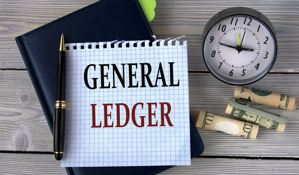 GENERAL LEDGER - words in a white notebook on the background of an alarm clock and a banknote