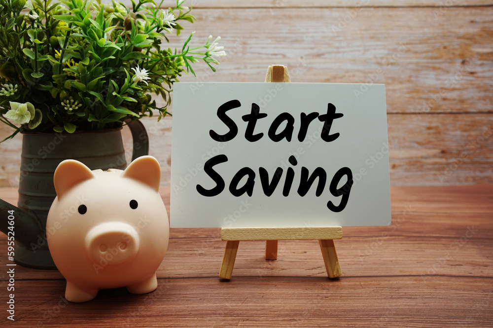 Poster start saving text message with piggy saving on wooden background