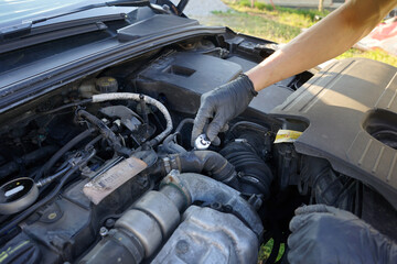 Mechanic checking the engine. Car service, mechanic repairing the engine. Worker inspecting car engine inside.