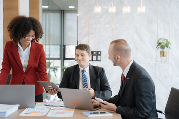 Mature business leader consultant talking to team of diverse colleagues listening to white CEO. Group project manager negotiating in the boardroom at a meeting.