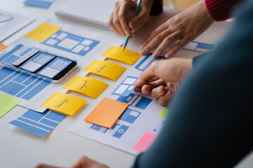 Creative team web designer planning application development for web mobile phone at modern workplace.