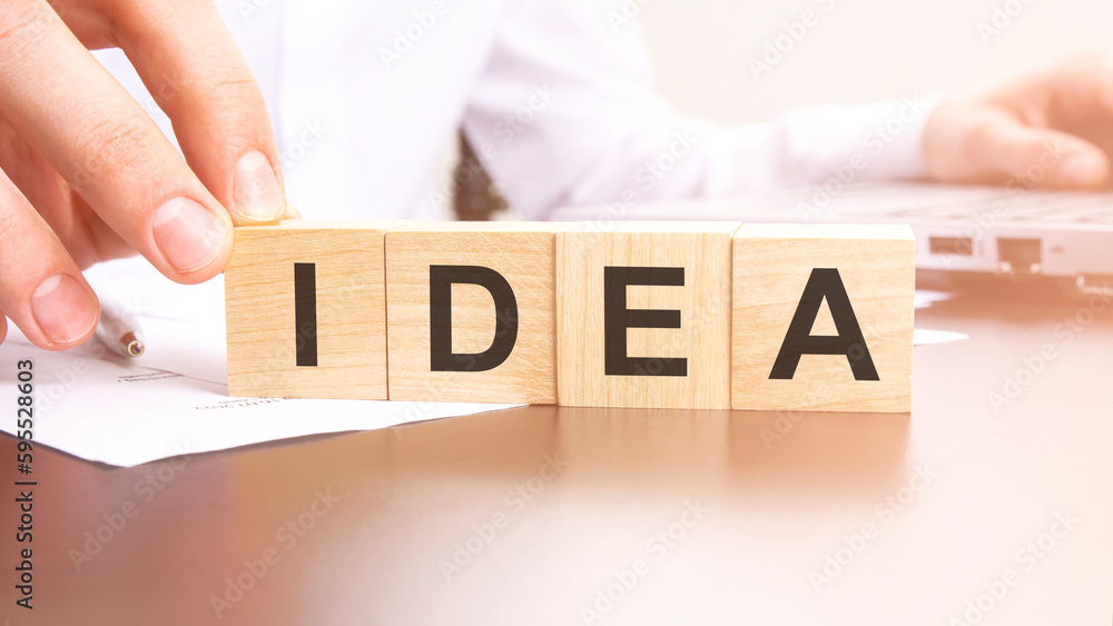 Poster man made text idea with wood blocks on the background of the office table. selective focus. business