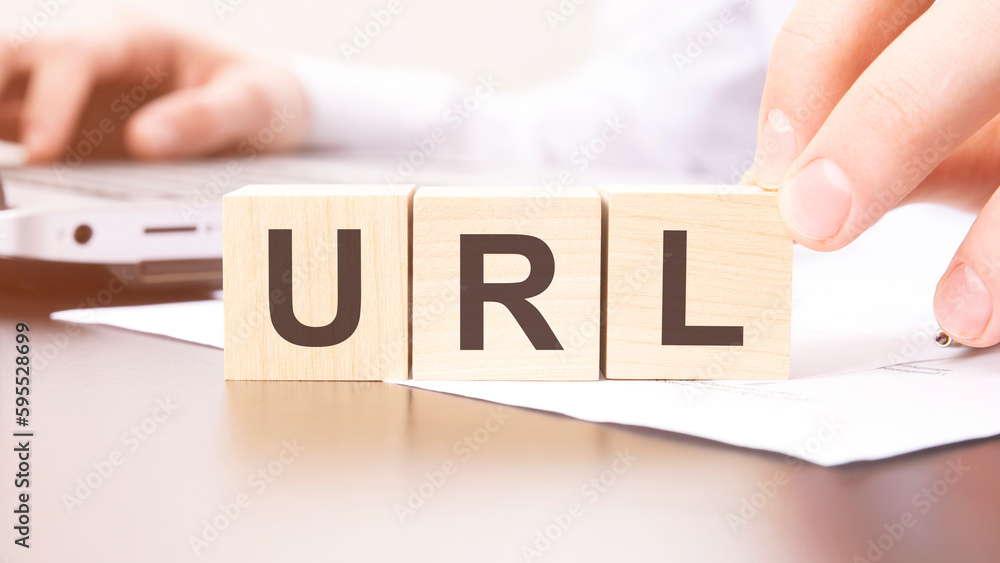 Poster hand holding wooden cube with url text on table background. financial, marketing and business concep