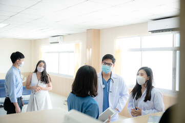 professional doctor and medicine person team have a conversation to talking in hospital about medical health care work, wearing surgical face mask