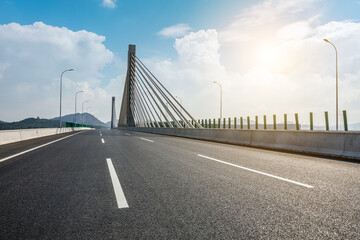 Asphalt road highway and bridge with sky clouds background