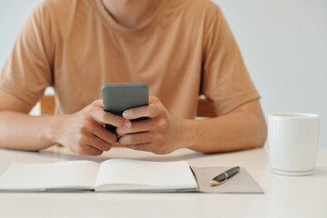 Fototapeta premium Businessman reading news on social media before filling planner