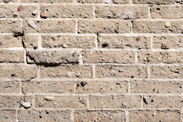 Brick wall with peeling plaster. Industrial background. Outline of falling plaster.
