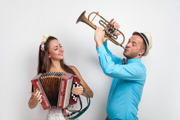 A young girl and a guy play musical instruments. Ukrainian couple.
