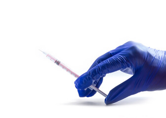 Hand in blue glove holding a syringe, isolated on white background. Health and medical concepts. COVID