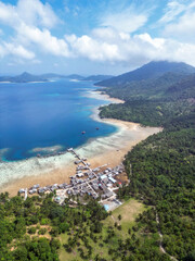 Indonesia Anambas Islands - Drone view Telaga Island coast line with village and vulcano