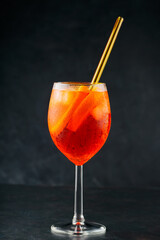 Aperol Spritz cocktail on dark background. Cocktail Aperol Spritz with oranges and ice in glass...