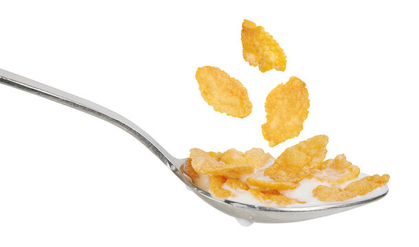 Corn flakes with milk in a spoon