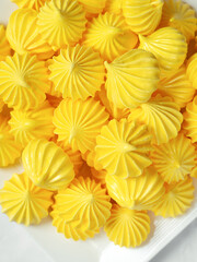 A close shot of a yellow delicious meringue on a background. Marshmallow background. Macro shot.