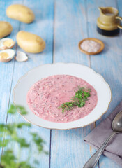 Fototapeta na wymiar A plate with cold beetroot soup - national dish of Baltic region