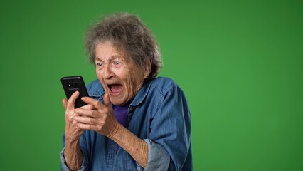 Funny crazy elderly old toothless woman answering smart phone call say wow as winner with success...