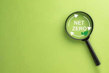 Net zero,Reduce CO2 emission concept.,Magnifying glass focus on Net zero icon over green background...